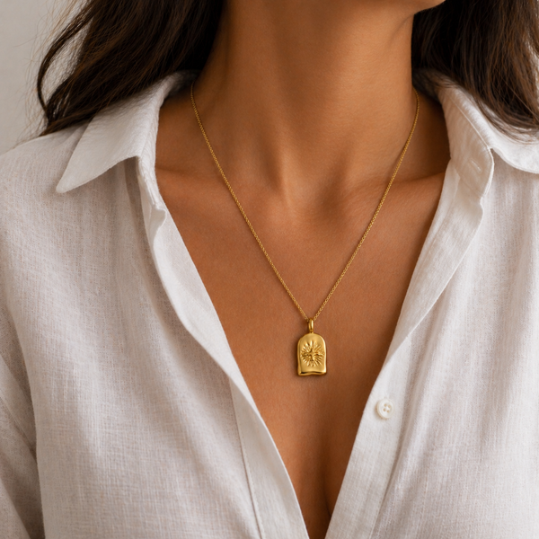 Astra Bird pendant necklace in gold and silver with sunburst detail, waterproof stainless steel jewellery