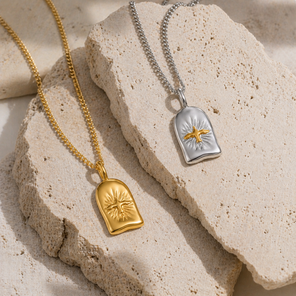 Astra Bird pendant necklace in gold and silver with sunburst detail, waterproof stainless steel jewellery