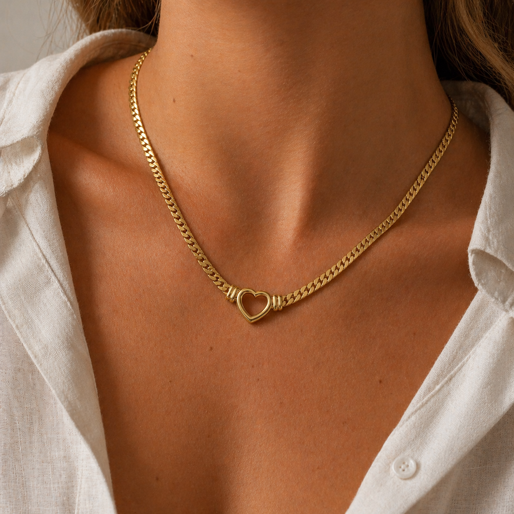 Chunky curb chain necklace with open heart pendant in gold and silver stainless steel on neutral background