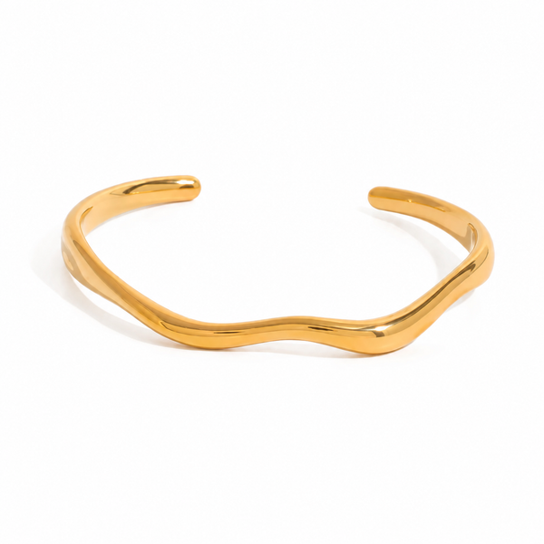 Gold and silver organic wave cuff bracelet on white background