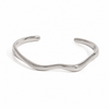 Gold and silver organic wave cuff bracelet on white background