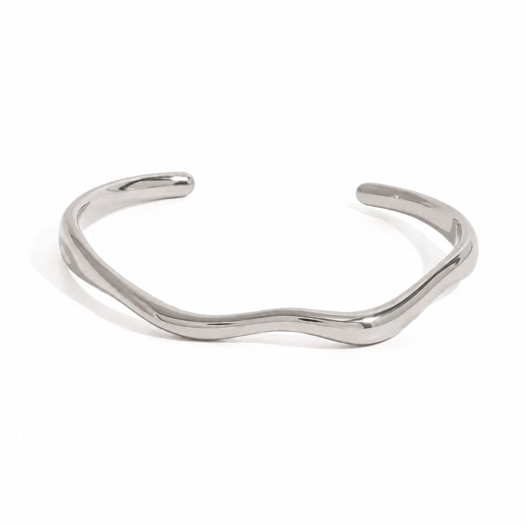 Gold and silver organic wave cuff bracelet on white background