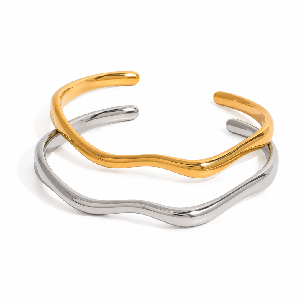 Gold and silver organic wave cuff bracelet on white background