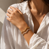 Gold and silver organic wave cuff bracelet on white background