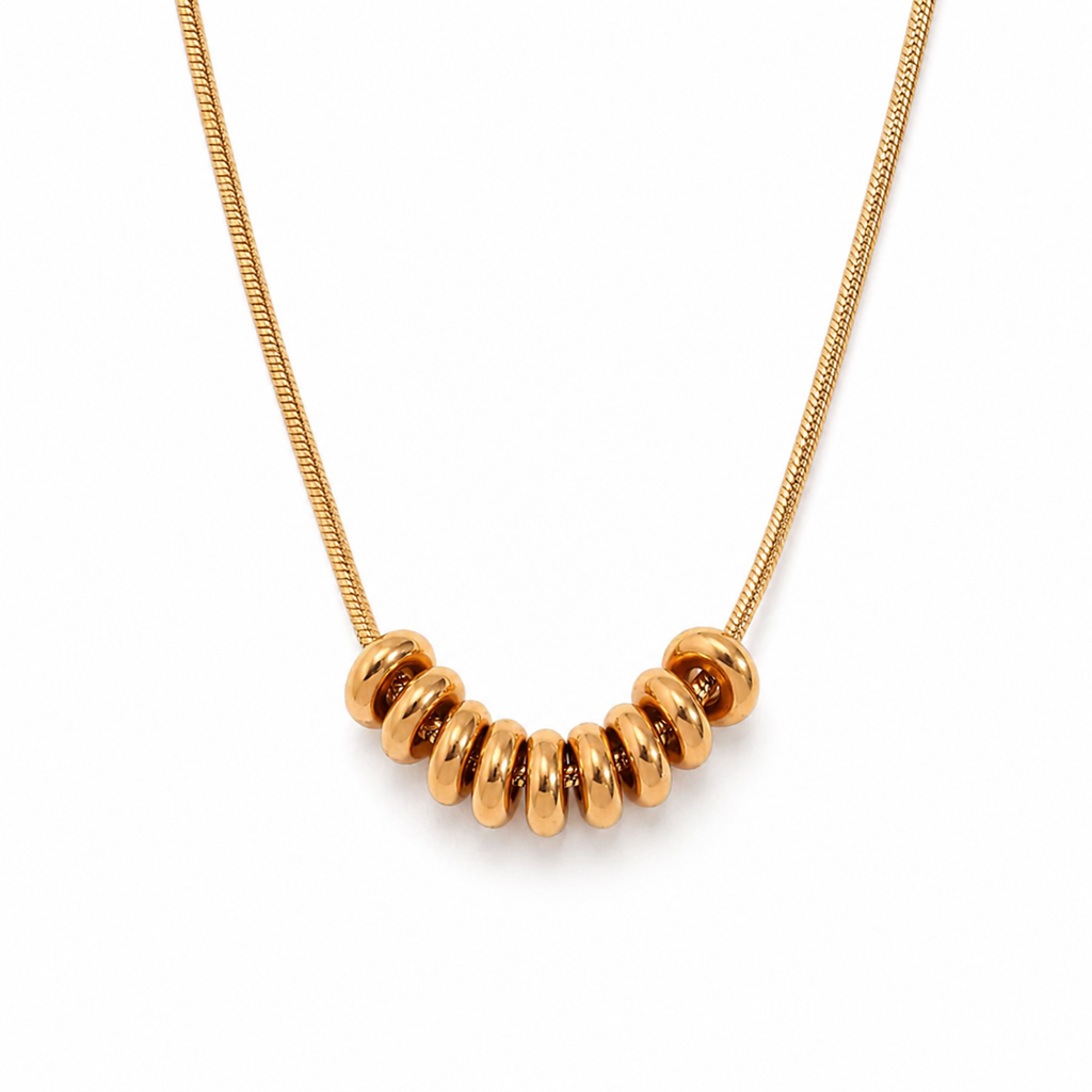 Drift Ring Necklace in gold PVD or stainless steel. Waterproof, ocean-proof, and designed for everyday wear. A minimal textured statement on a snake chain.