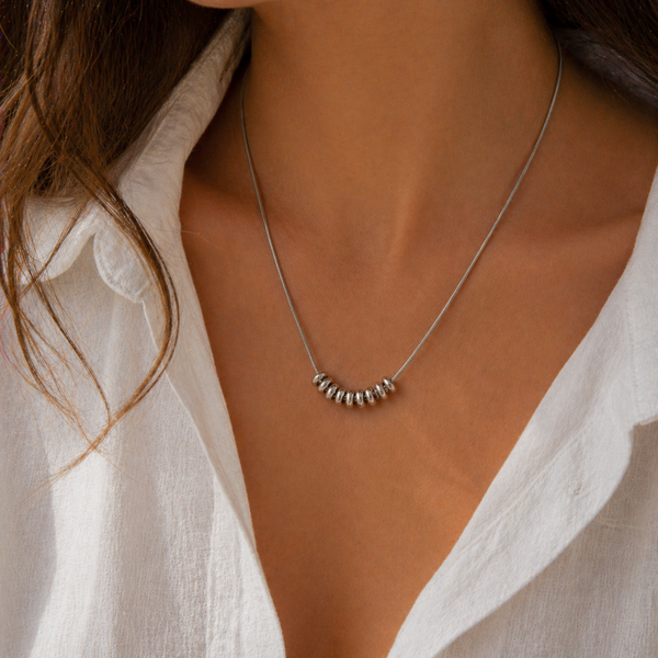 Drift Ring Necklace in gold PVD or stainless steel. Waterproof, ocean-proof, and designed for everyday wear. A minimal textured statement on a snake chain.