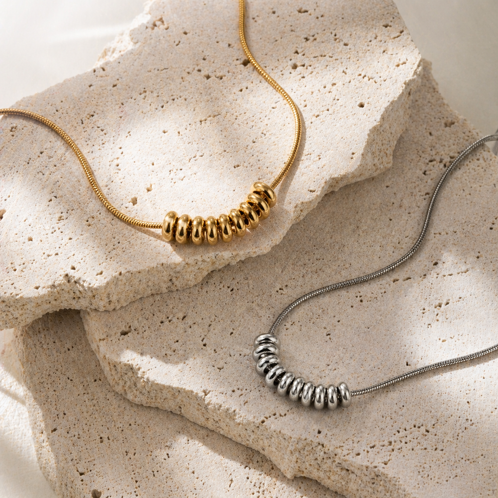 Drift Ring Necklace in gold PVD or stainless steel. Waterproof, ocean-proof, and designed for everyday wear. A minimal textured statement on a snake chain.