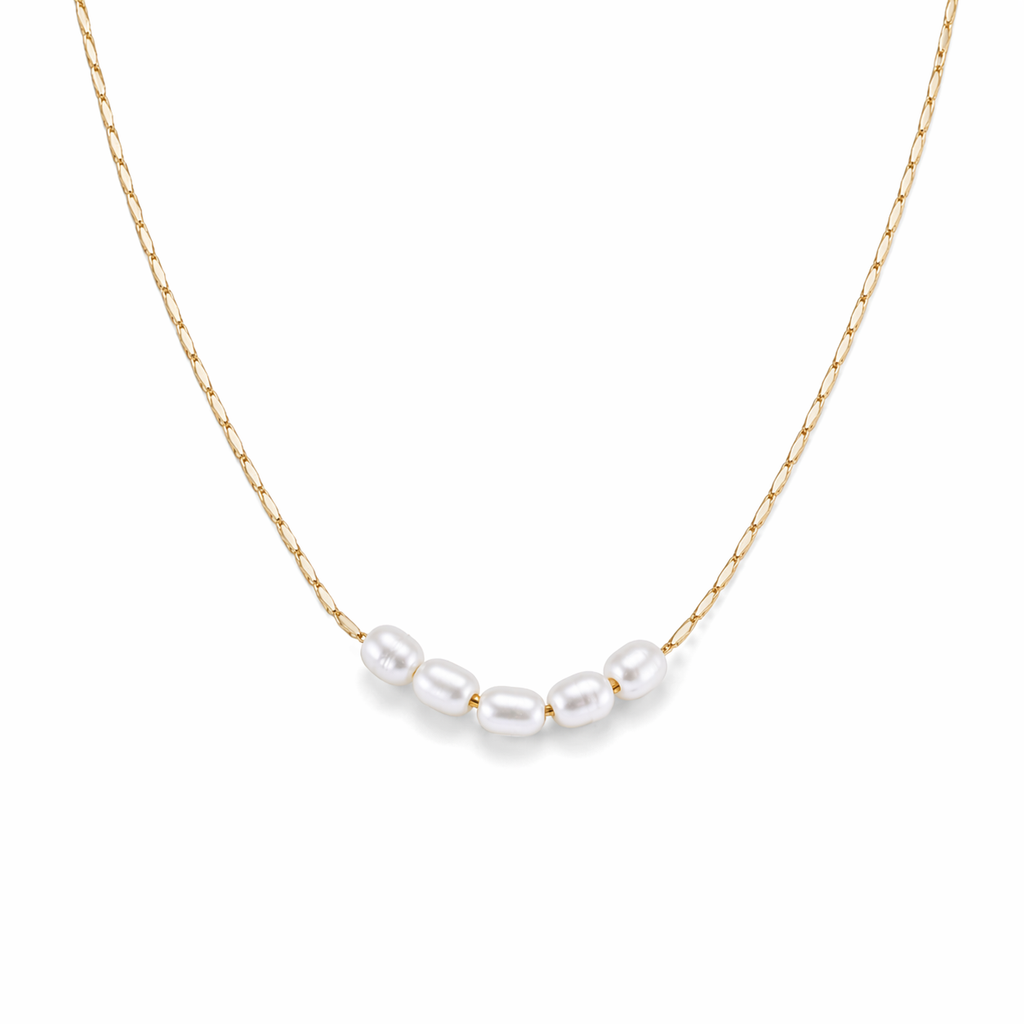 Lagoon pearl necklace with five organic pearls spaced along a fine stainless steel chain, available in gold and silver, worn at collarbone length.