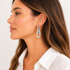 Gold and silver chain-link drop earrings with polished finish and huggie hoop closure on white background.