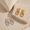 Gold and silver chain-link drop earrings with polished finish and huggie hoop closure on white background.