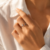 Gold and silver celestial moon and star adjustable ring with deep blue gemstone on white background.