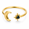 Gold and silver celestial moon and star adjustable ring with deep blue gemstone on white background.