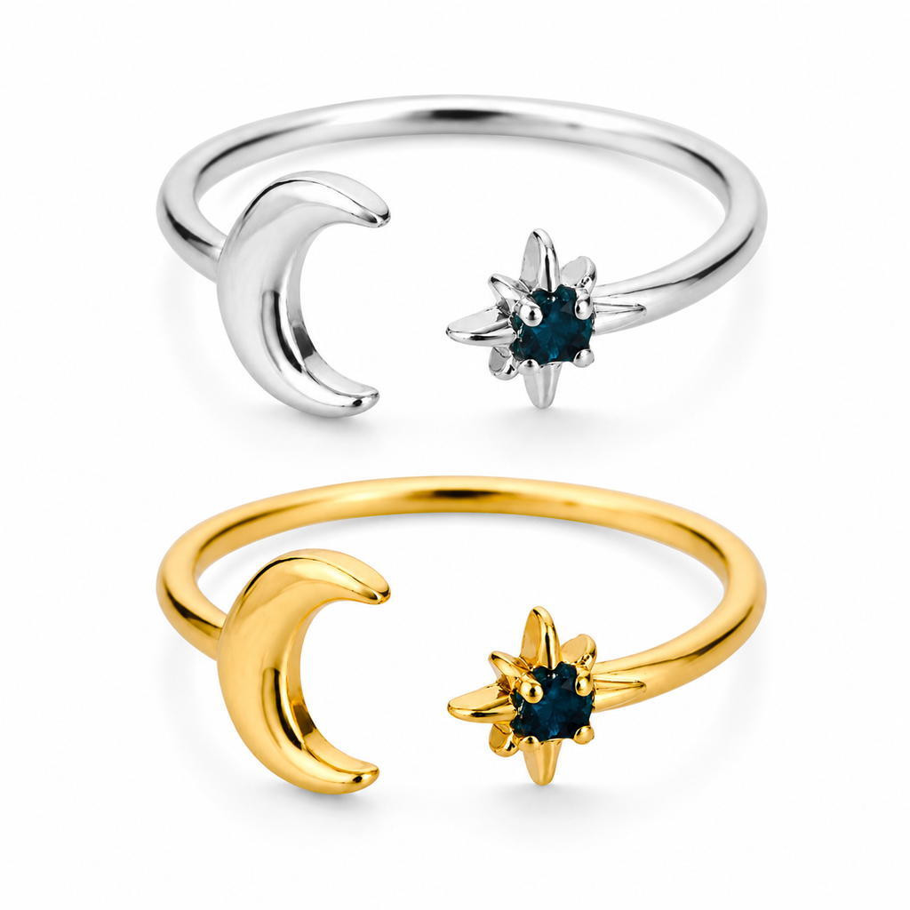 Gold and silver celestial moon and star adjustable ring with deep blue gemstone on white background.