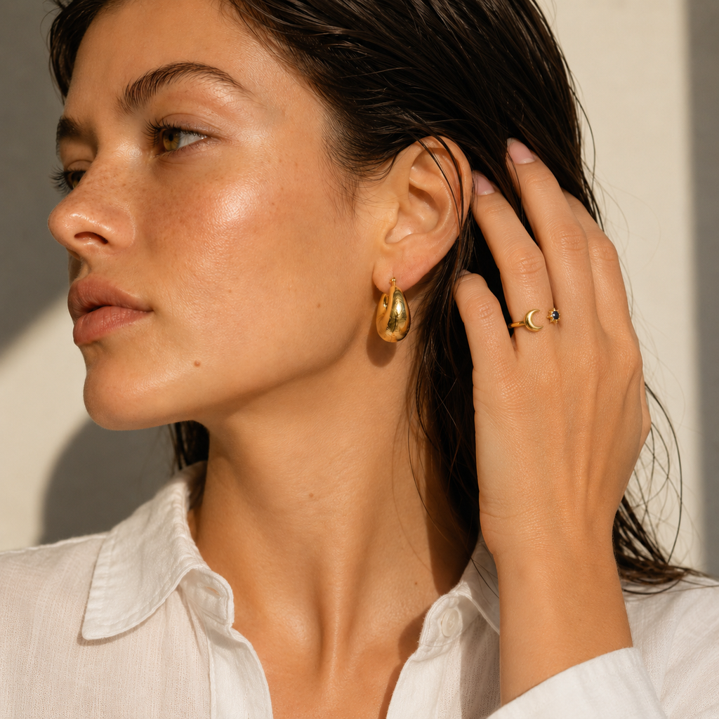 Gold and silver celestial moon and star adjustable ring with deep blue gemstone on white background.