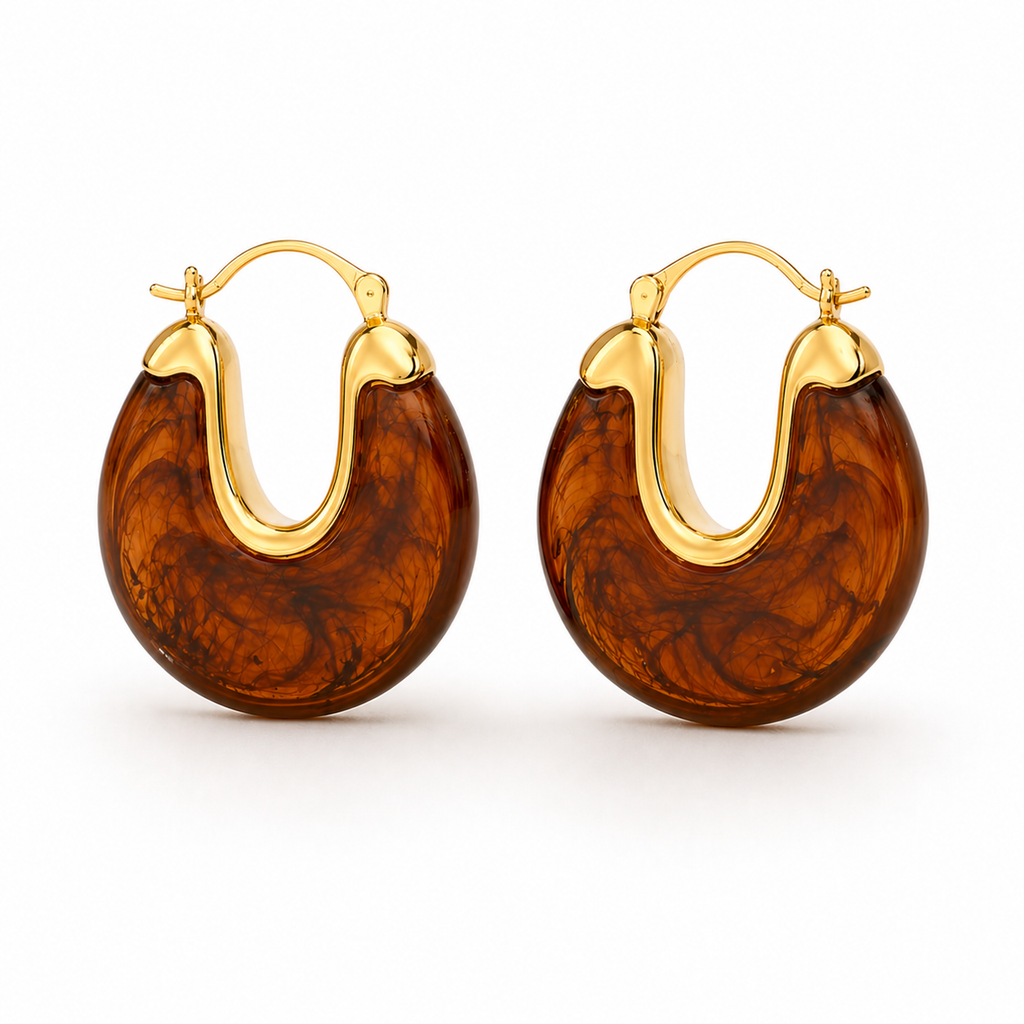 Gold hoop earrings with glossy marbled resin in pearl, smoke, and amber colour options on a white background.
