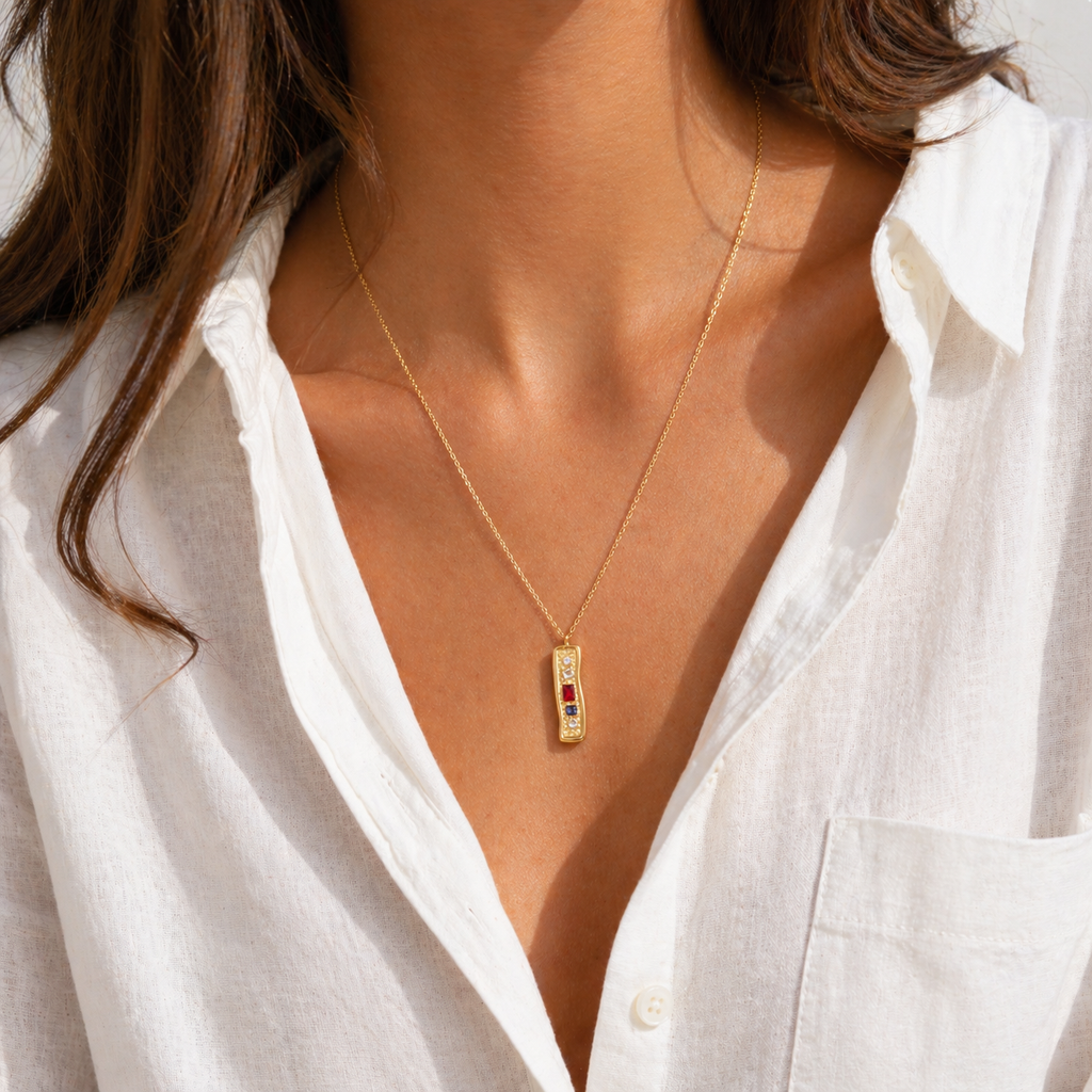 Textured bar pendant necklace with mixed stones in gold and silver finishes on a fine chain, modern coastal-inspired jewellery.