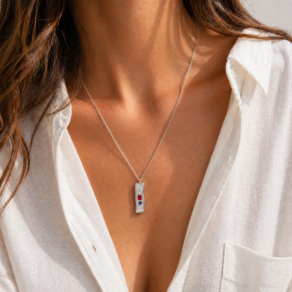 Textured bar pendant necklace with mixed stones in gold and silver finishes on a fine chain, modern coastal-inspired jewellery.
