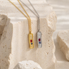 Textured bar pendant necklace with mixed stones in gold and silver finishes on a fine chain, modern coastal-inspired jewellery.