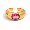 Gold and silver adjustable statement rings with oval pink crystal stones on a white background.