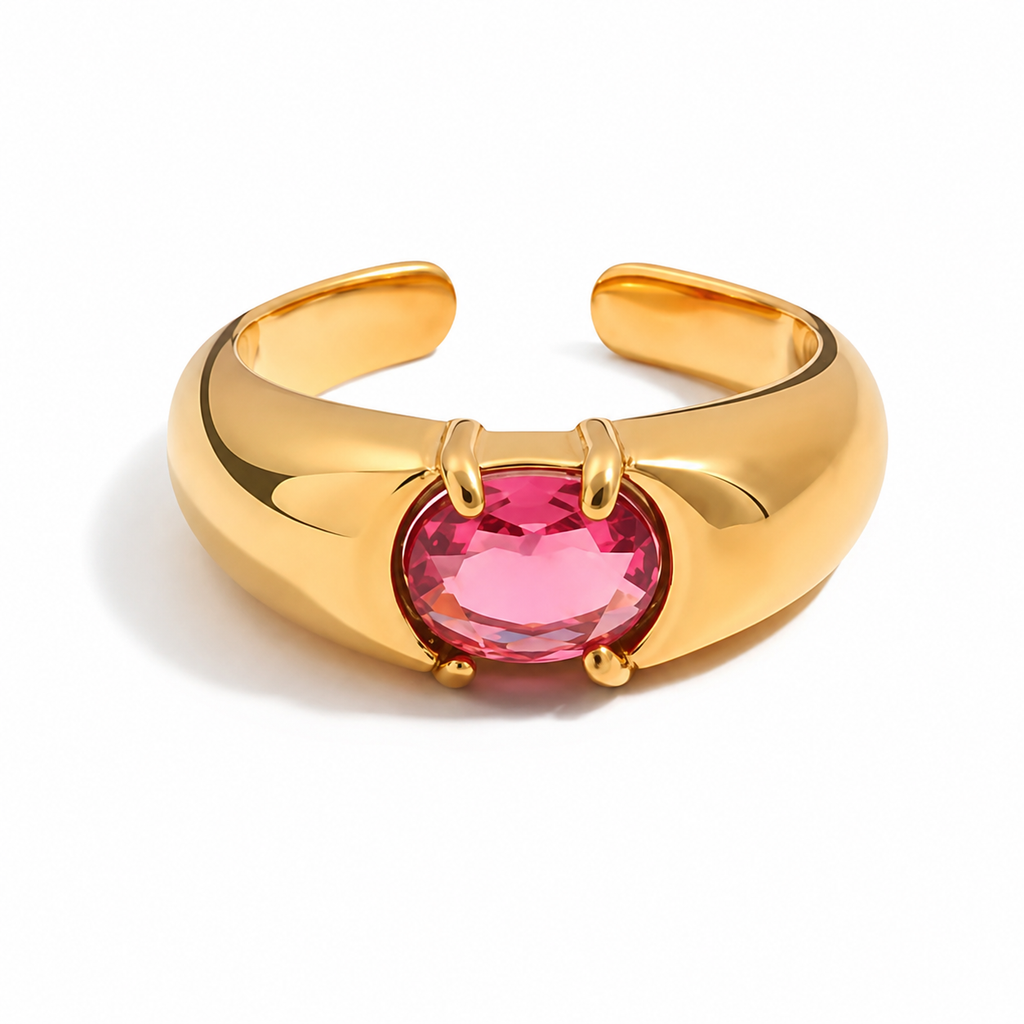 Gold and silver adjustable statement rings with oval pink crystal stones on a white background.