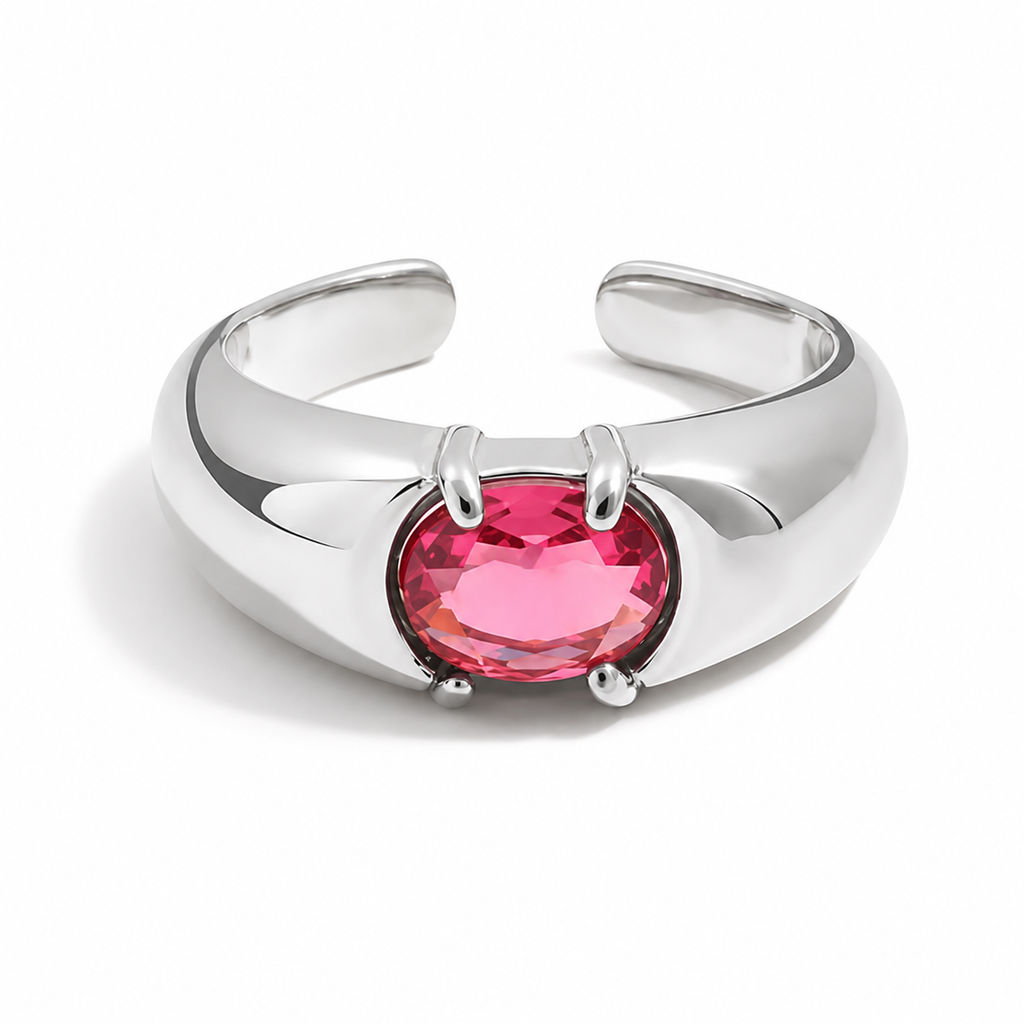 Gold and silver adjustable statement rings with oval pink crystal stones on a white background.