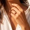 Gold and silver adjustable statement rings with oval pink crystal stones on a white background.