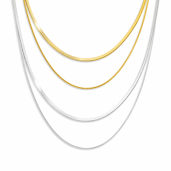 Gold layered necklace featuring a flat snake chain and fine chain creating a minimal stacked jewellery look