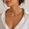Gold layered necklace featuring a flat snake chain and fine chain creating a minimal stacked jewellery look