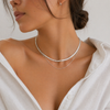Gold layered necklace featuring a flat snake chain and fine chain creating a minimal stacked jewellery look