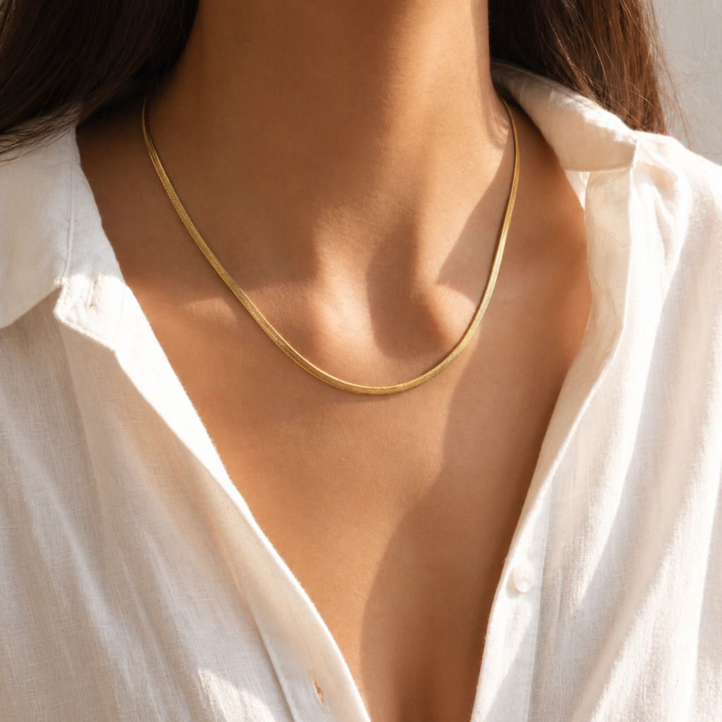 Gold flat 3mm chain necklace worn on neck with smooth reflective finish, minimal modern jewellery style