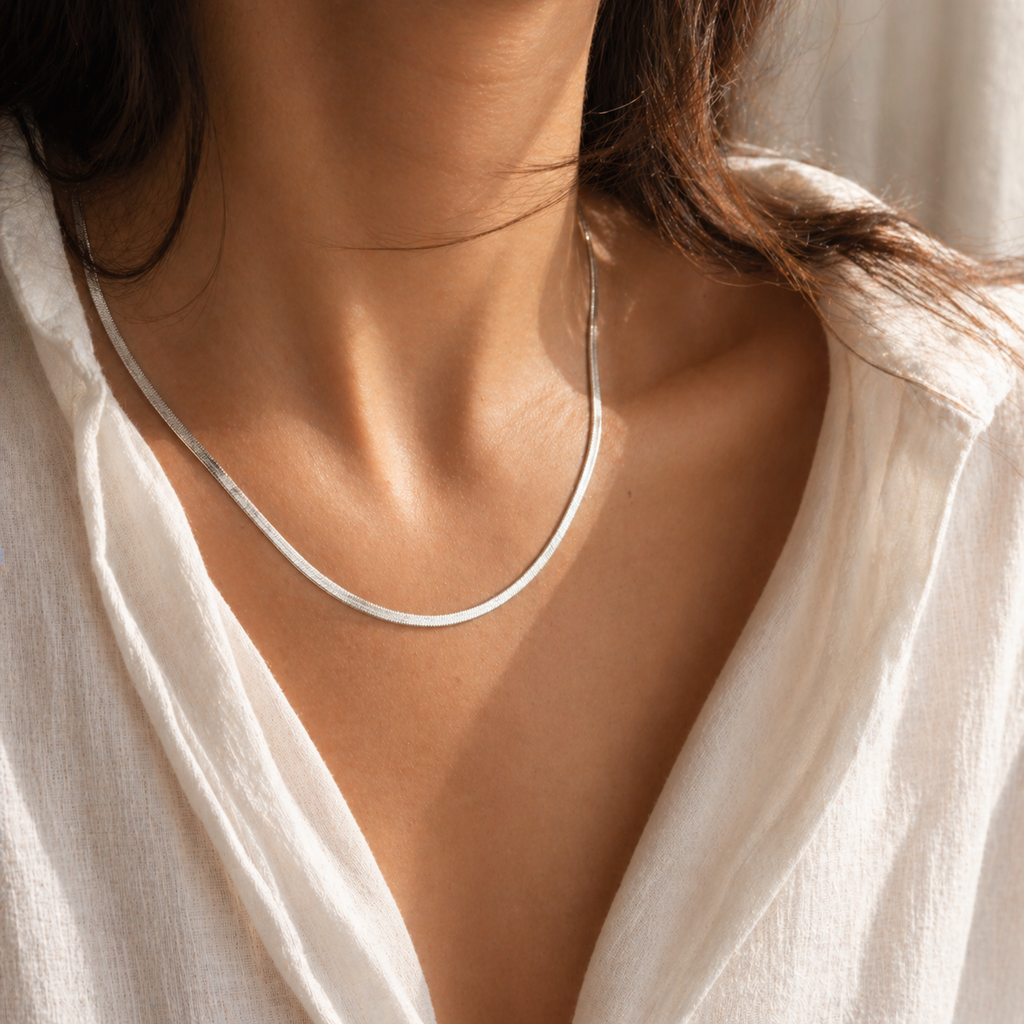 Gold flat 3mm chain necklace worn on neck with smooth reflective finish, minimal modern jewellery style