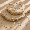 Gold flat 3mm chain necklace worn on neck with smooth reflective finish, minimal modern jewellery style
