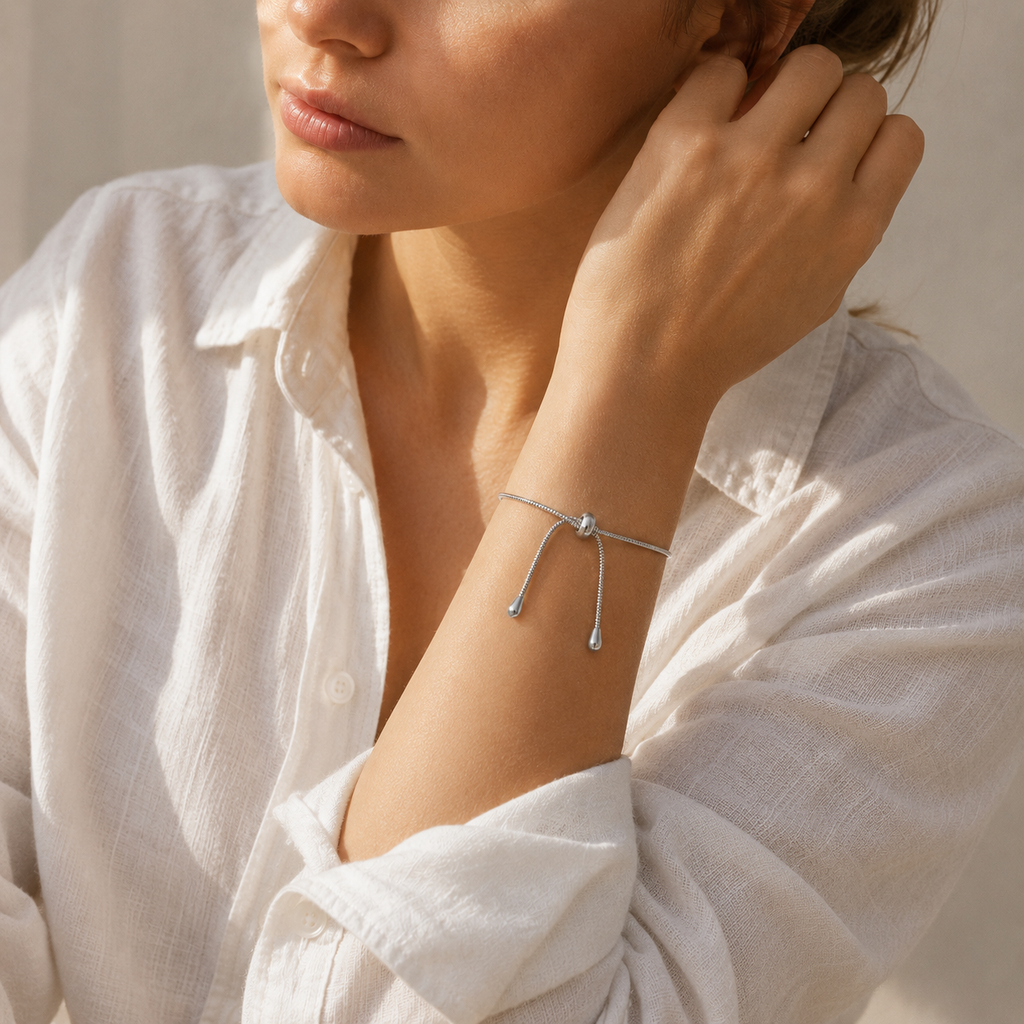 Adjustable snake chain bracelet with sliding clasp in gold and silver stainless steel on white background