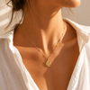 Gold celestial medallion pendant necklace featuring eye, moon and star detailing with coloured gemstones on a fine beaded chain.