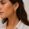 Gold and silver celestial hoop earrings with sun, moon and star detailing on a textured wide band, waterproof and ocean-proof, 20mm diameter.