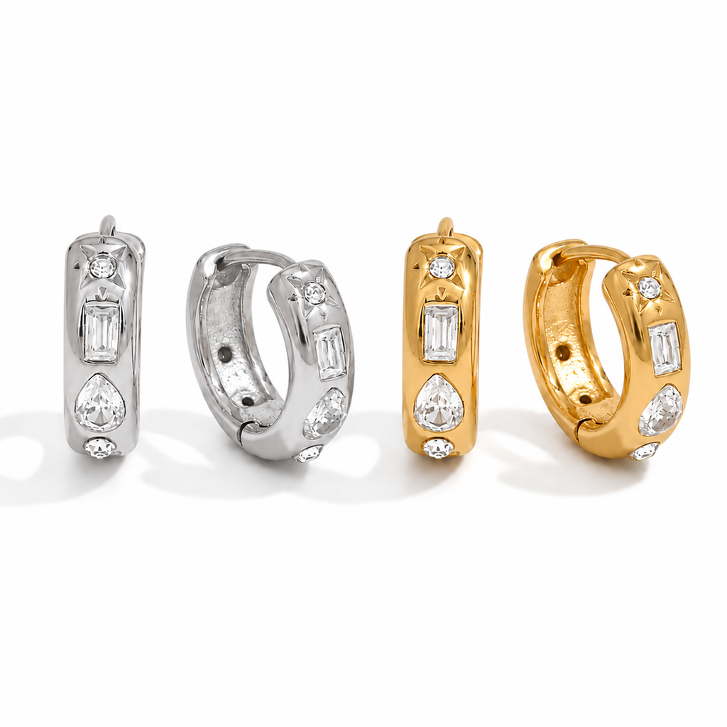 Gold and silver huggie earrings with clear cubic zirconia stones and a star detail on a polished finish.