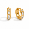Gold and silver huggie earrings with clear cubic zirconia stones and a star detail on a polished finish.