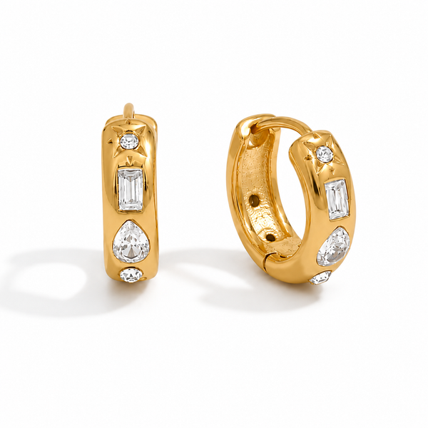 Gold and silver huggie earrings with clear cubic zirconia stones and a star detail on a polished finish.