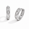 Gold and silver huggie earrings with clear cubic zirconia stones and a star detail on a polished finish.