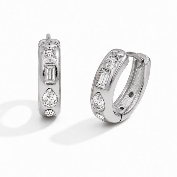Gold and silver huggie earrings with clear cubic zirconia stones and a star detail on a polished finish.