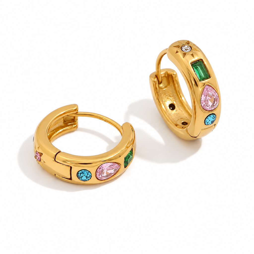 Gold and silver huggie earrings with colourful gemstone settings including green, pink, and blue stones with a star detail.