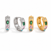 Gold and silver huggie earrings with colourful gemstone settings including green, pink, and blue stones with a star detail.