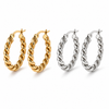 Twisted rope hoop earrings in gold and silver, 2.4cm diameter with a thick textured design and latch closure.