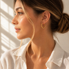 Twisted rope hoop earrings in gold and silver, 2.4cm diameter with a thick textured design and latch closure.