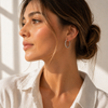 Twisted rope hoop earrings in gold and silver, 2.4cm diameter with a thick textured design and latch closure.