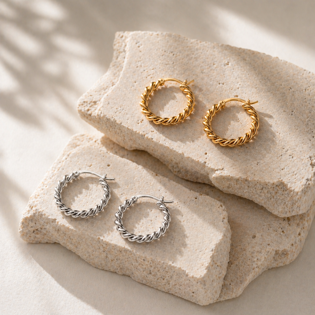Twisted rope hoop earrings in gold and silver, 2.4cm diameter with a thick textured design and latch closure.