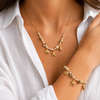 Gold PVD beaded charm bracelet and necklace with shell and starfish pendants on a fine chain