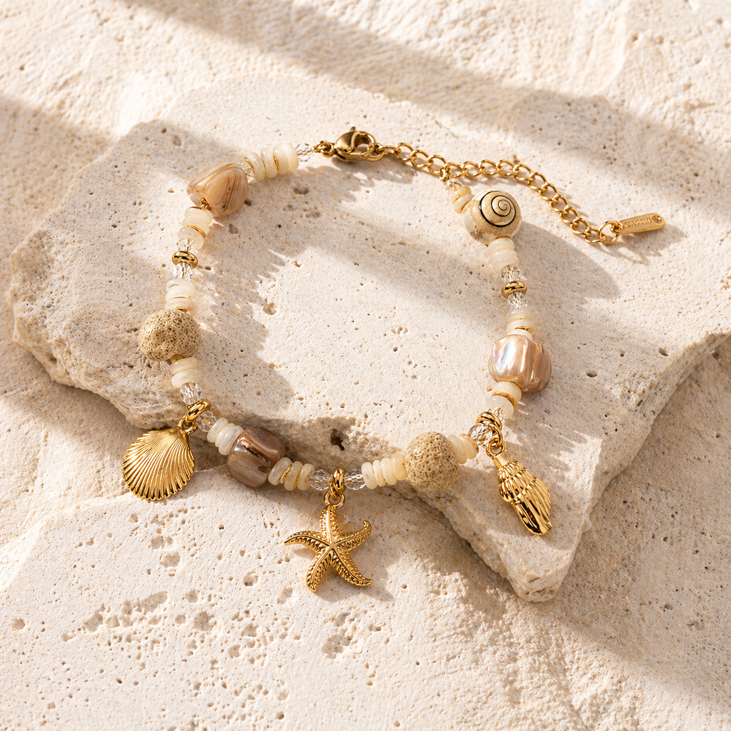 Gold PVD beaded charm bracelet with shell and starfish pendants on a fine chain